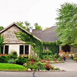 Beautiful rambler home located on an acre and a half of wooded land surrounded by gardens.